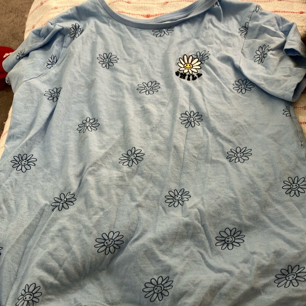I am selling a blue flower t-shirt that says smile
